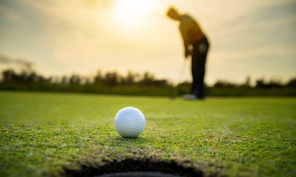 A golfer almost getting to the hole