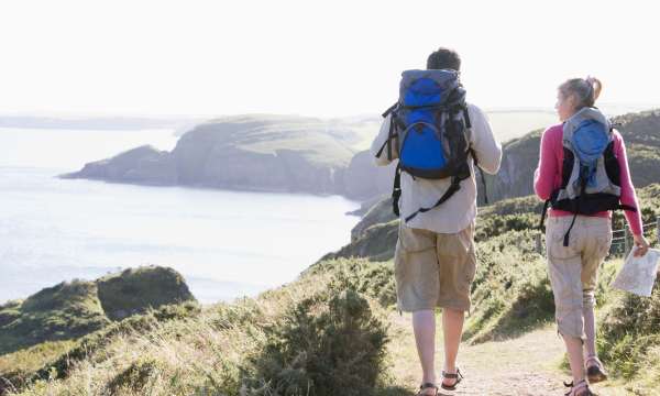 Couple walking along a coastal path