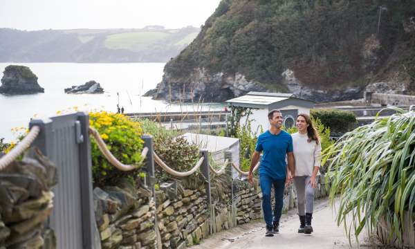 couple walking up path holidaying hands in charlestown