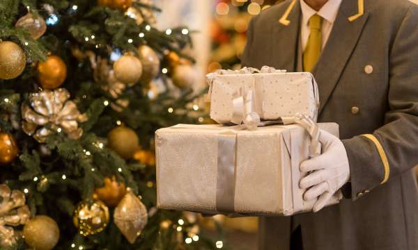 Porter at Carlyon Bay Hotel holding presents