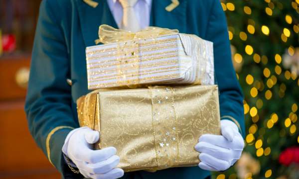 Porter holding presents outside The Victoria Hotel