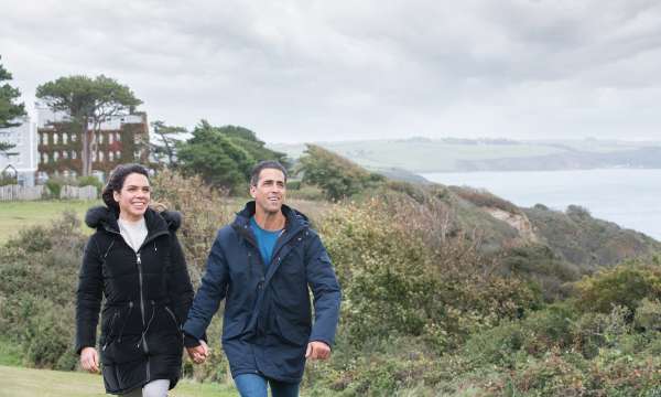 couple walking from Carlyon Bay Hotel