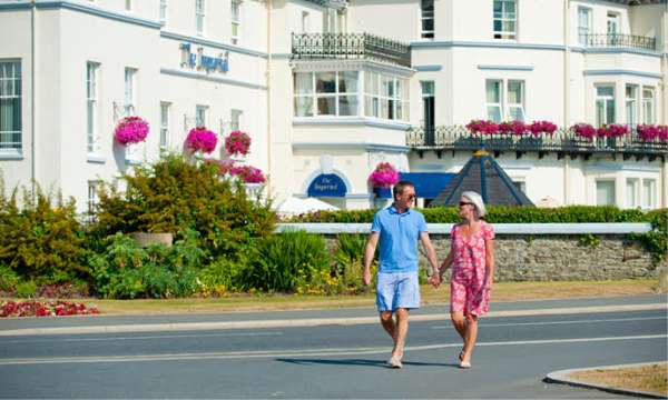 Couple walking outside the Imperial hotel in Barnstaple on a warm sunny day