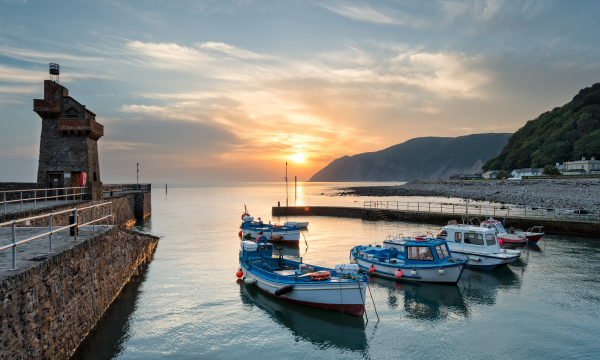 Boats mored at Lynmouth Harbour at sunset