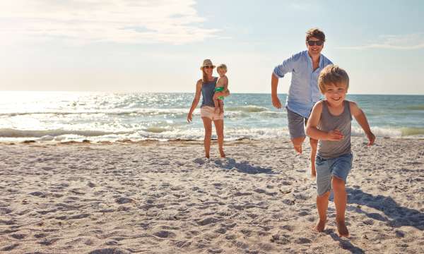 Family running on beach