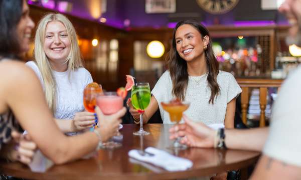 group of 4 eating and drinking in 62 the bank