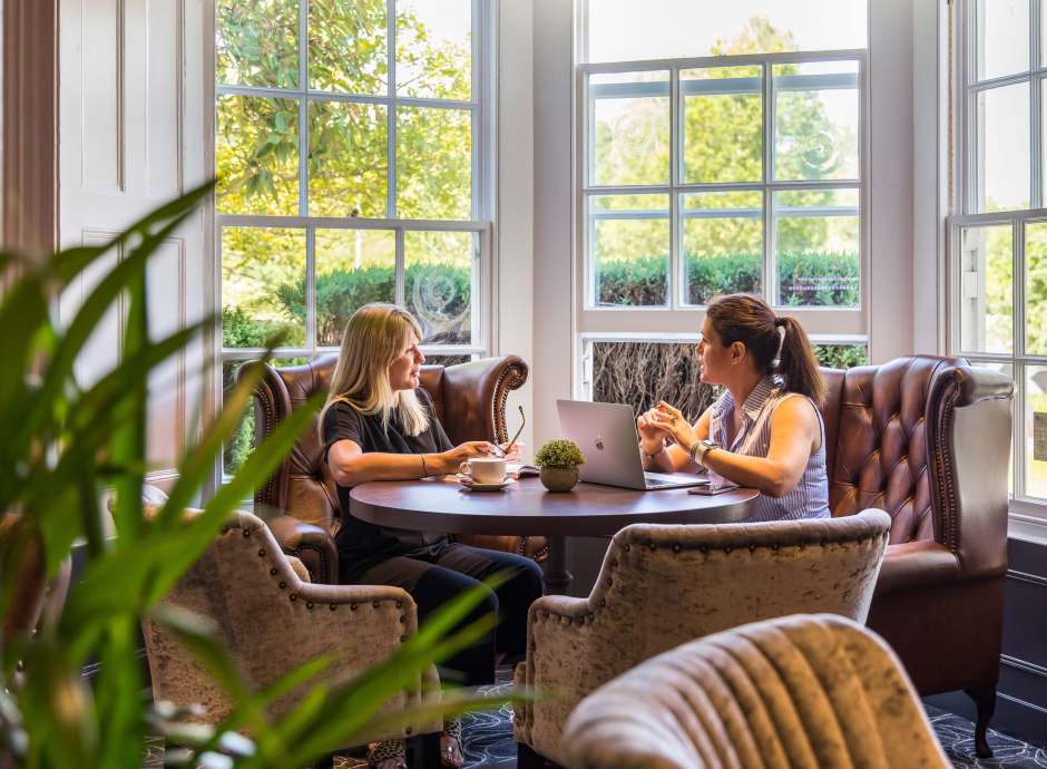 Devon Hotel Carriages Restaurant Two Guests Having a Meeting over Coffees