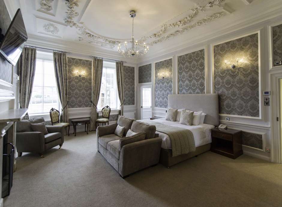 Royal Hotel Accommodation Bedroom with Lounge Area and Fireplace