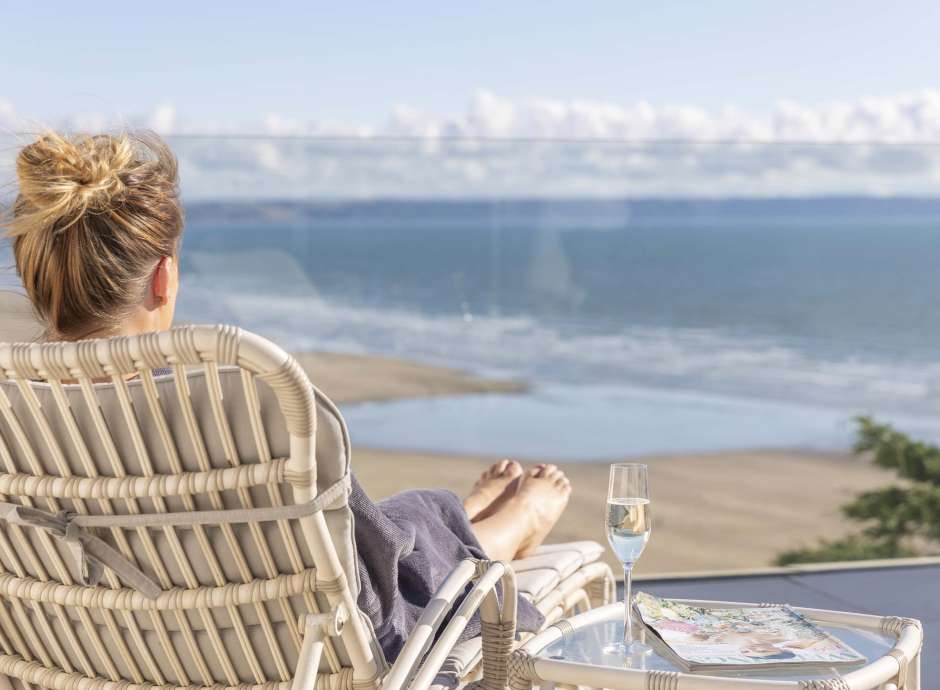 Saunton Sands Hotel Source Spa Guest Relaxing on Sun Lounger with Glass of Champagne Looking Over Saunton Beach