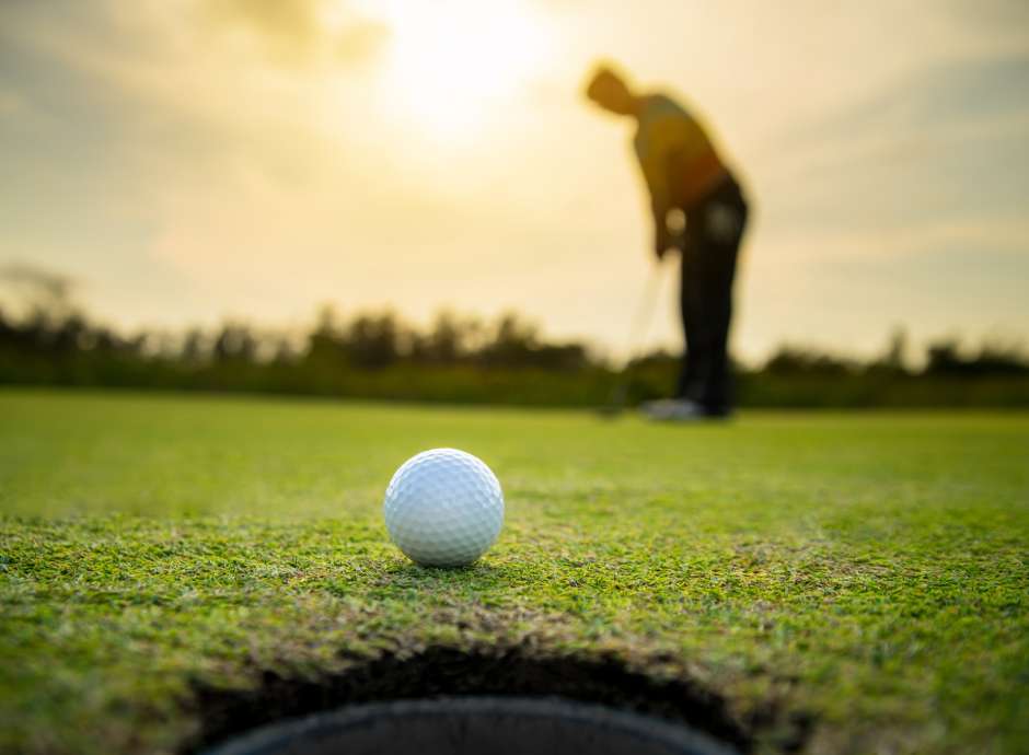 A golfer almost getting to the hole