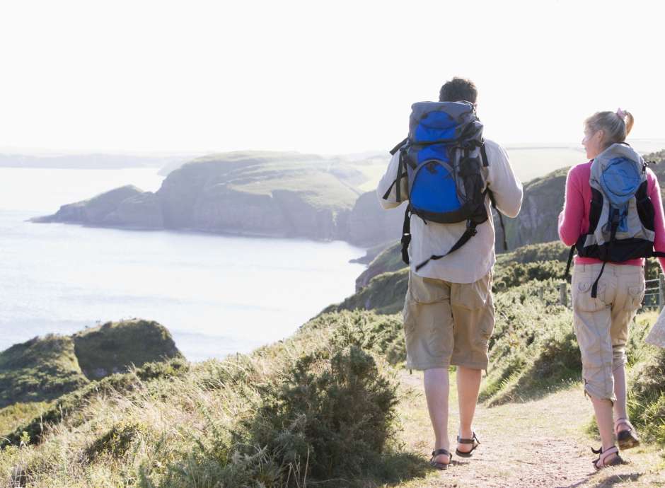 Couple walking along a coastal path