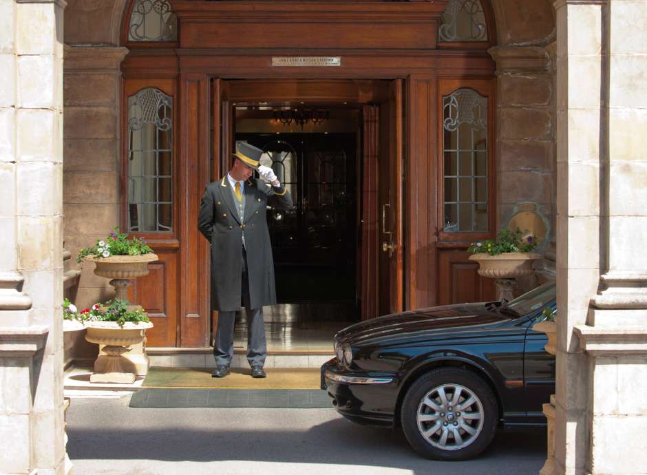 Doorman welcoming car at the Victoria hotel 