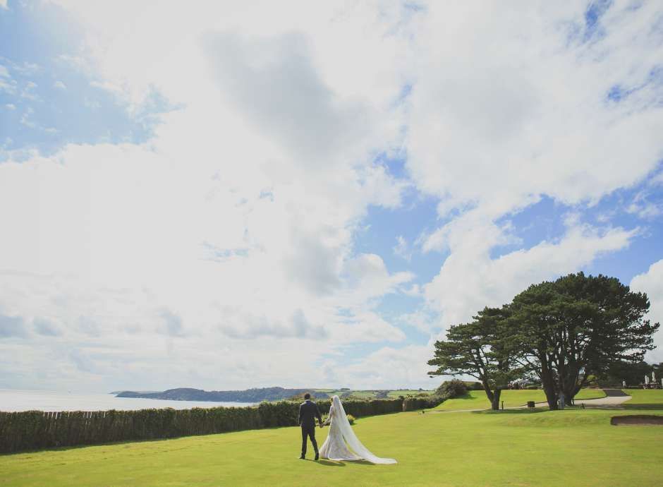 exclusive use wedding at carlyon bride and groom walking in grounds