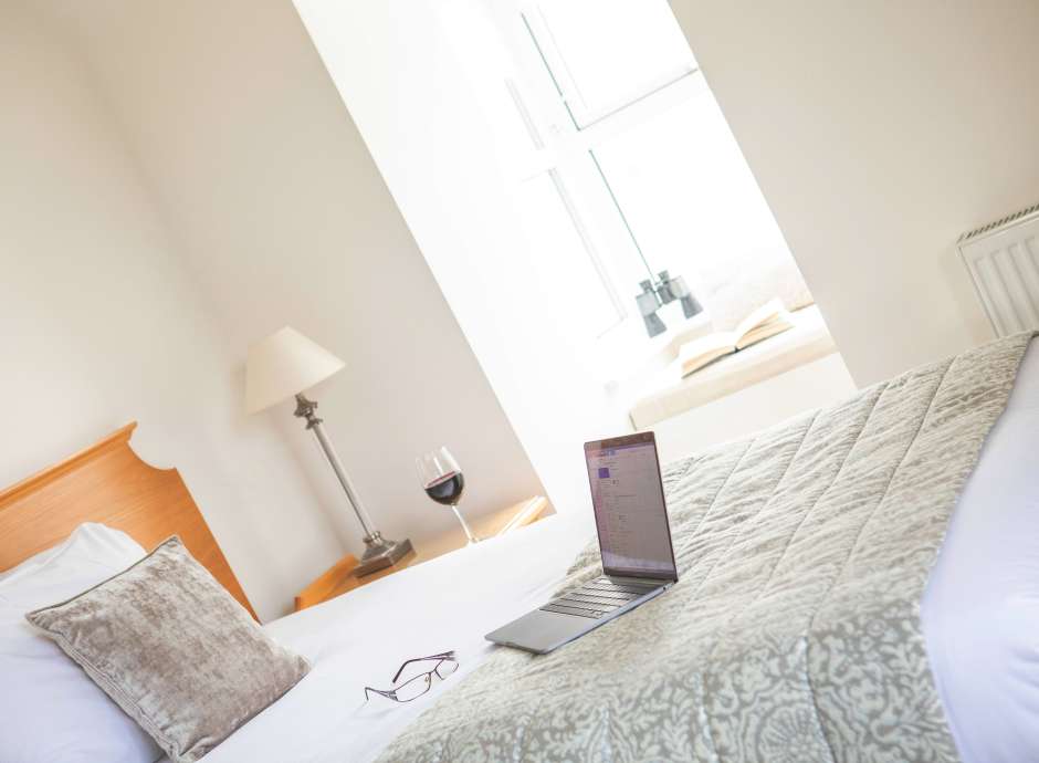 royal duchy corporate bedroom laptop on bed