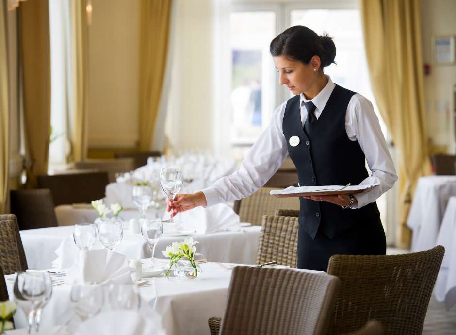 saunton sands dining room waitress laying table