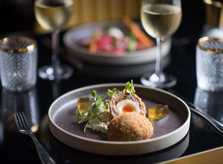 scotch egg and salmon starter in background
