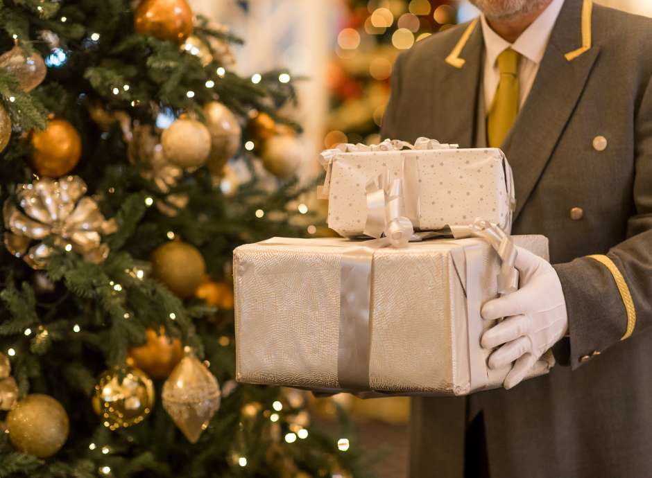 Porter at Carlyon Bay Hotel holding presents