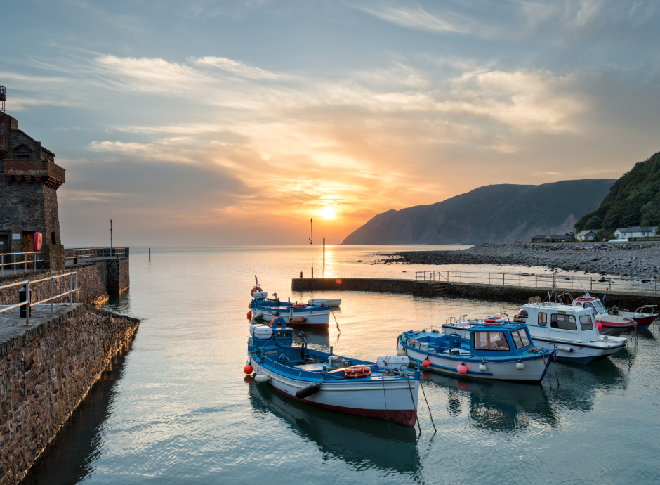 Boats mored at Lynmouth Harbour at sunset