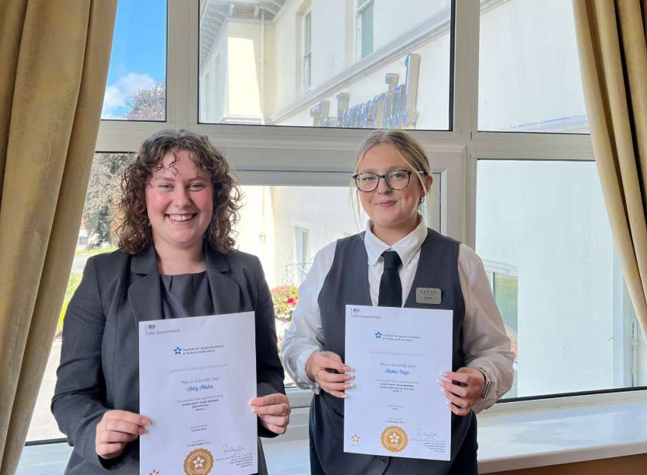 2 girls holding apprenticeship certificates 