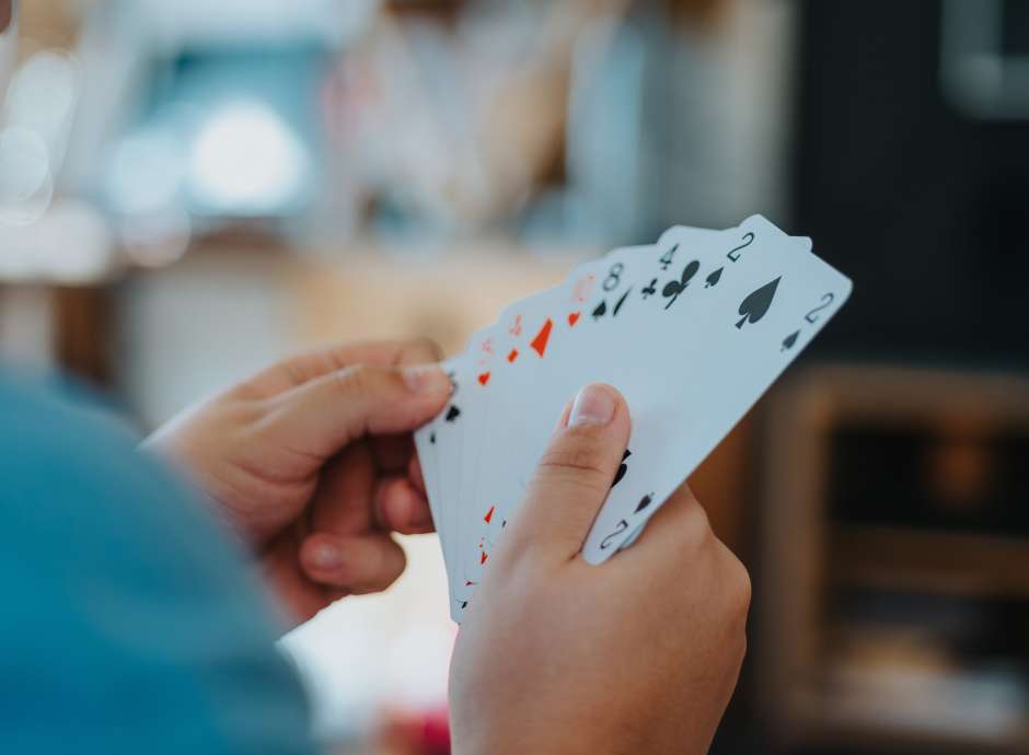 Person holding cards in hand