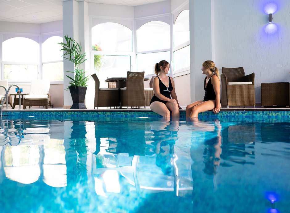 two ladies sitting by the indoor pool at The Royal Duchy Hotel