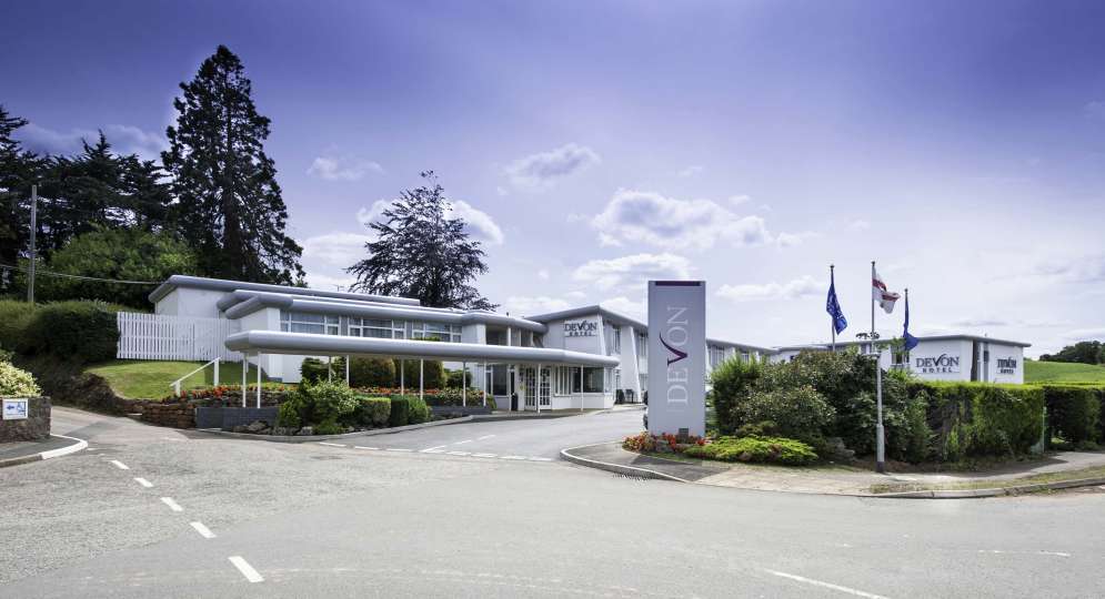 Devon Hotel Exterior with Sign and Flags