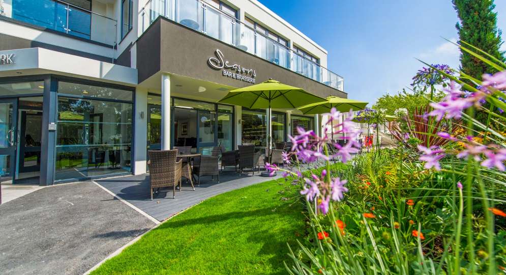 Park Hotel Seasons Bar and Brasserie External View with Outdoor Seating and Flowers